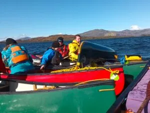 A group of caneists rescuing a capsised paddler
